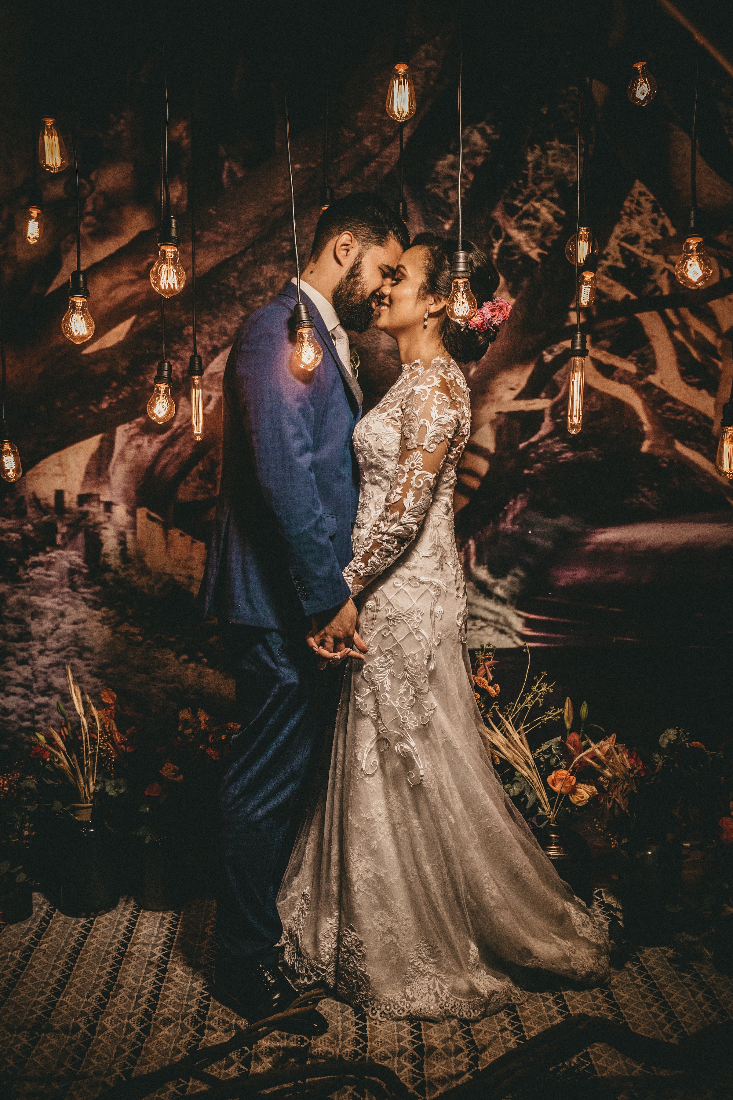 Bride and Groom at Rustic Wedding Reception with Hanging Light Bulbs