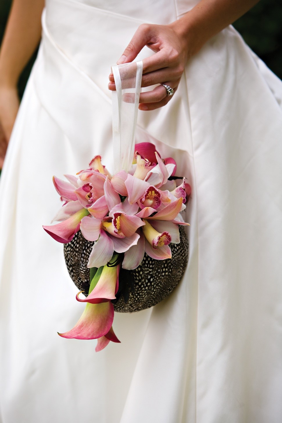 Bride with pretty pink orchid wedding bouquet