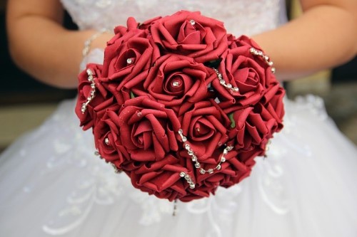 autumn wedding bouquet with red roses and bouquet jewelry