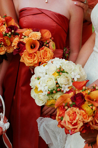 Bride and bridesmaid Wedding Photo - Bride with White Bouquet, bridesmaids with striking orange floral bouquets