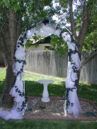 Pretty green and white wedding arch
