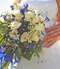 bride holding blue and white bridal bouquet