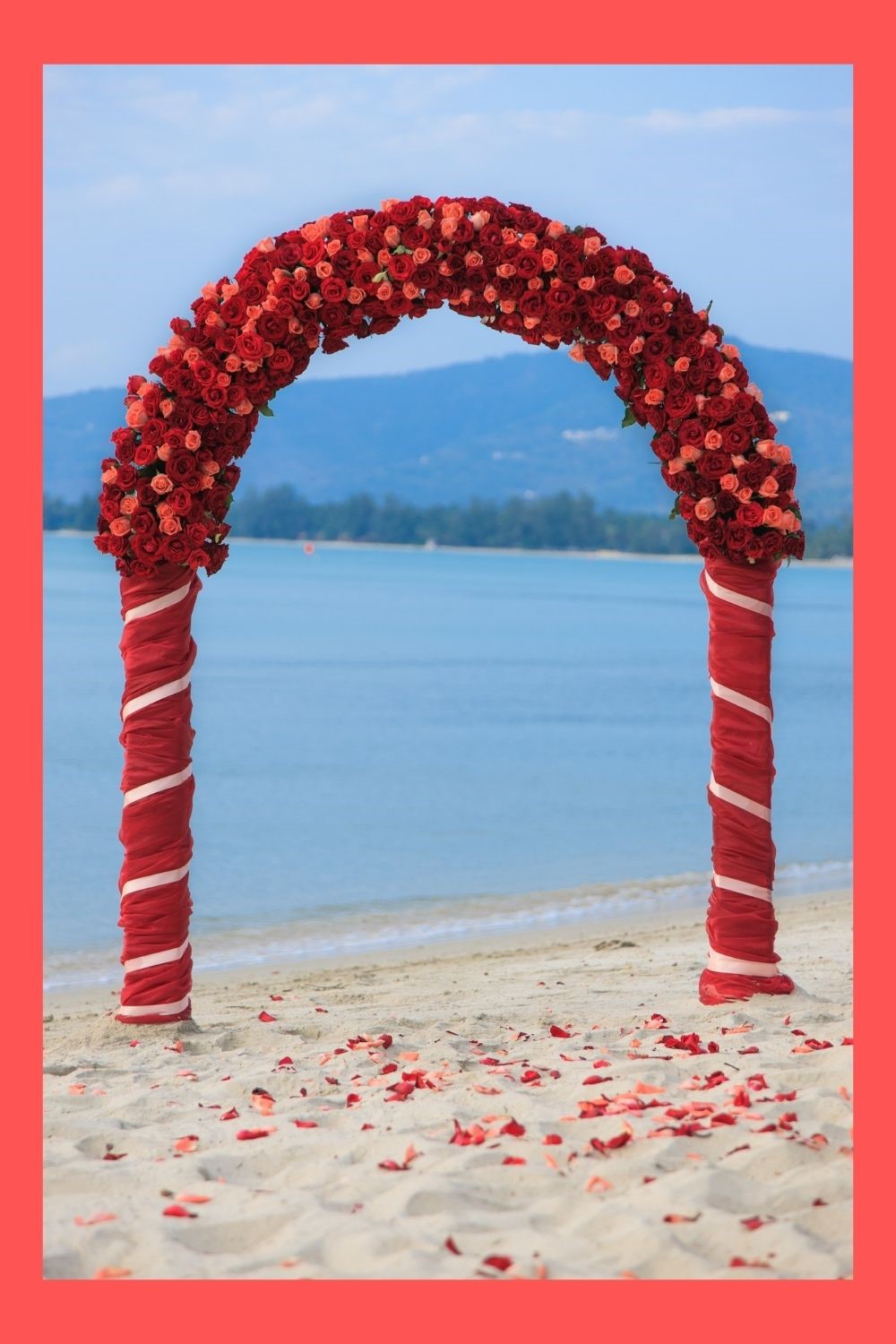Red and White striped bridal arch covered in hundreds of pink and red roses