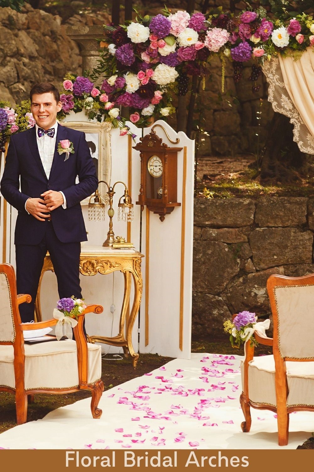 Groom Under Purple, White and Pink Lush Floral Bridal Arch