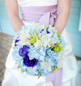 Bride holding Blue, white and green wedding bouquet