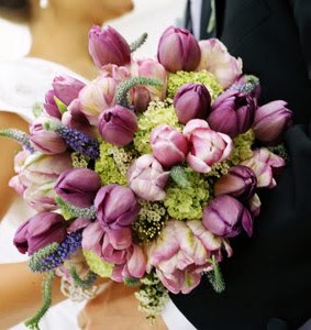 bride with beautiful purple wedding flowers