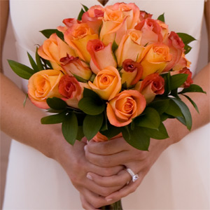 Bride Holding Orange rose bouquet