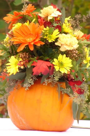 Creative Pumpkin Wedding Centerpiece Filled With Fall Wedding Flowers