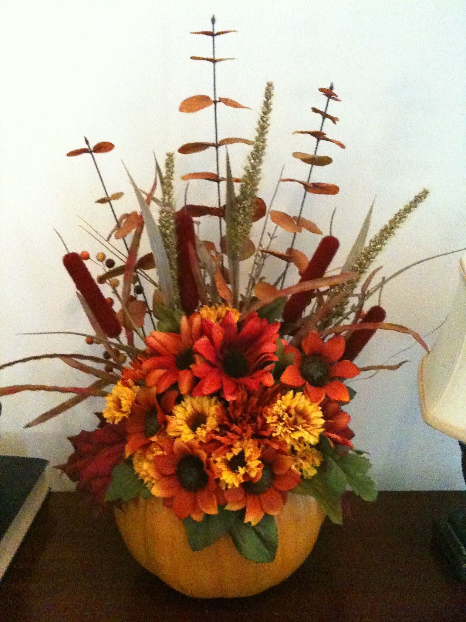 Cute Pumpkin centerpiece with autumn flowers and greenery