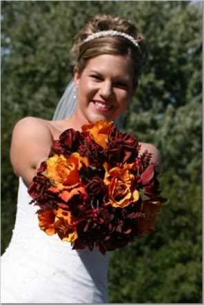 Bride Holding Dramatic Red and Orange Bridal Bouquet