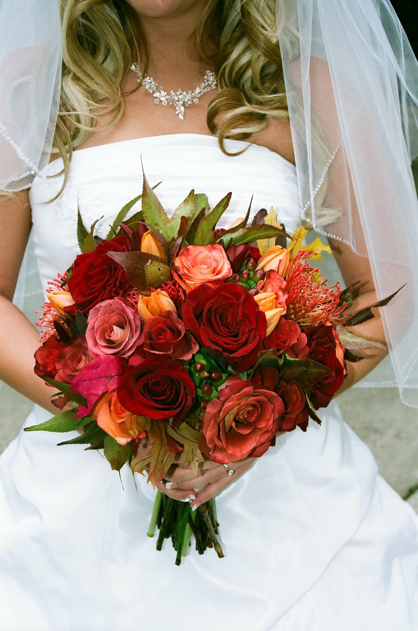Bride Holding Beautiful Pink, Yellow and Orange Wedding Bouquet