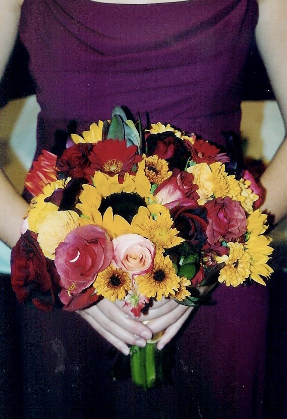 Bridesmaid wearing Deep Purple Dress Holding a Fall Wedding Bouquet (yellow, pink and red)