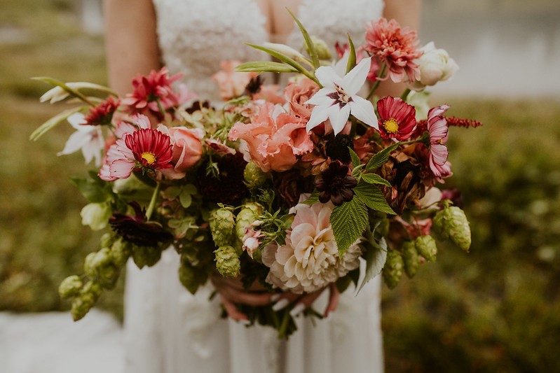 Bride holding gorgeous bohemian fall wedding bouquet