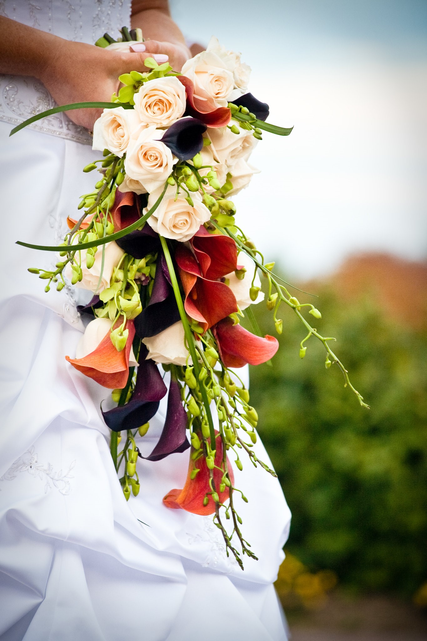 Bride Holding Orange, Purple and Cream Colored Autumn Wedding Bouquet
