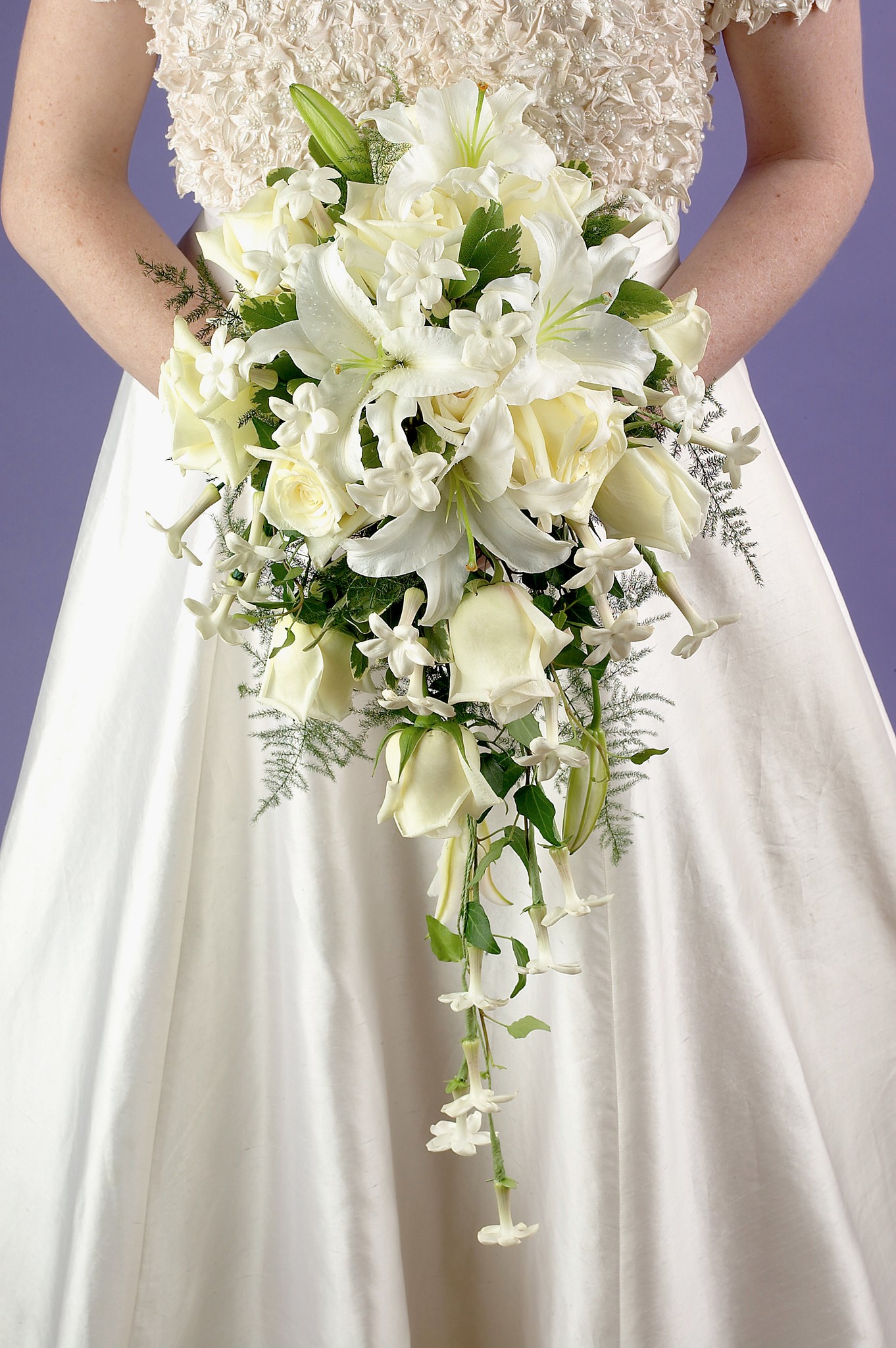 Bride Holding White and Green Cascading Bridal Bouquet