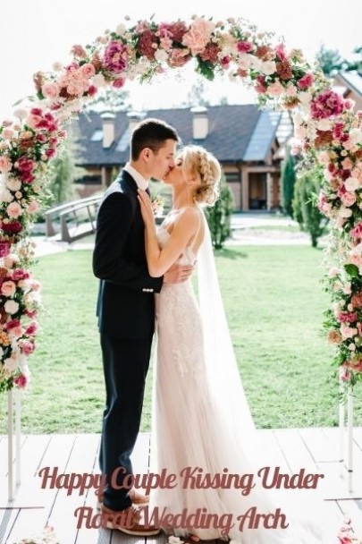 wedding ceremony ideas, floral wedding arch, bride and groom kissing under floral wedding arch