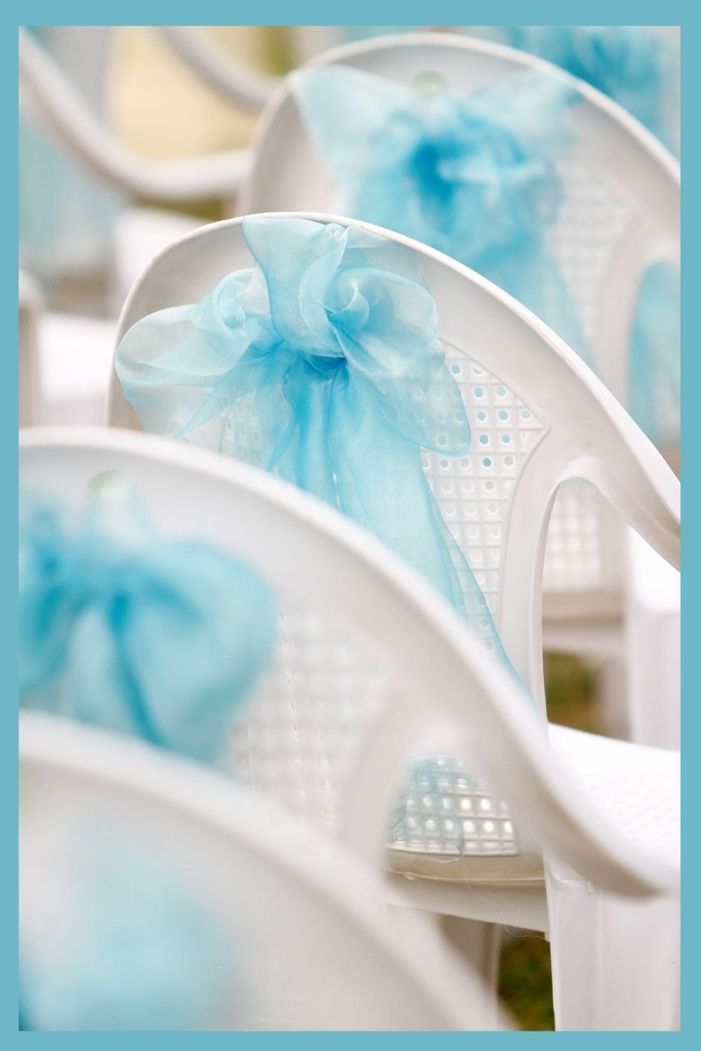white wedding chairs decorated with baby blue tulle bows