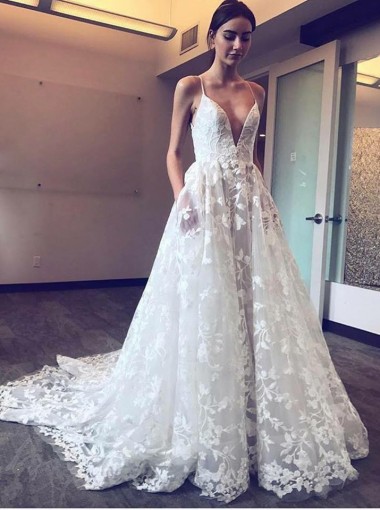 Bride wearing a stunning and unique A-Line Spaghetti Straps Lace Wedding Dress with Pockets