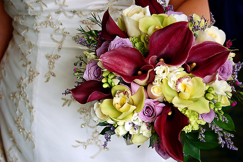 bride holding beautiful colorful wedding bouquet