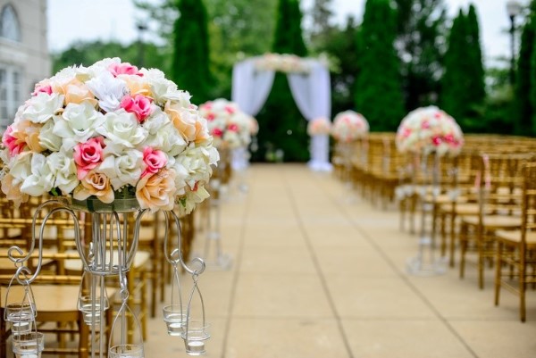 Gorgeous White, pink and orange flower arrangements in church wedding