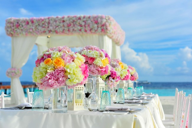 beach wedding reception with beautiful floral centerpieces