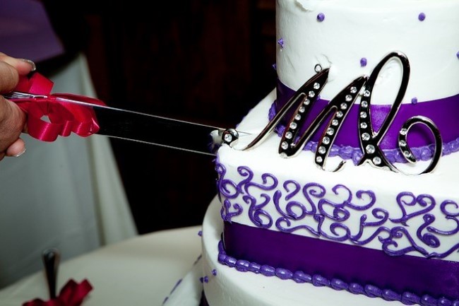 purple and white wedding cake with monogrammed wedding cake topper