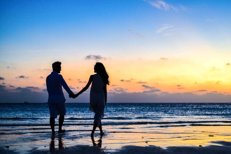happy couple on the beach at sunset