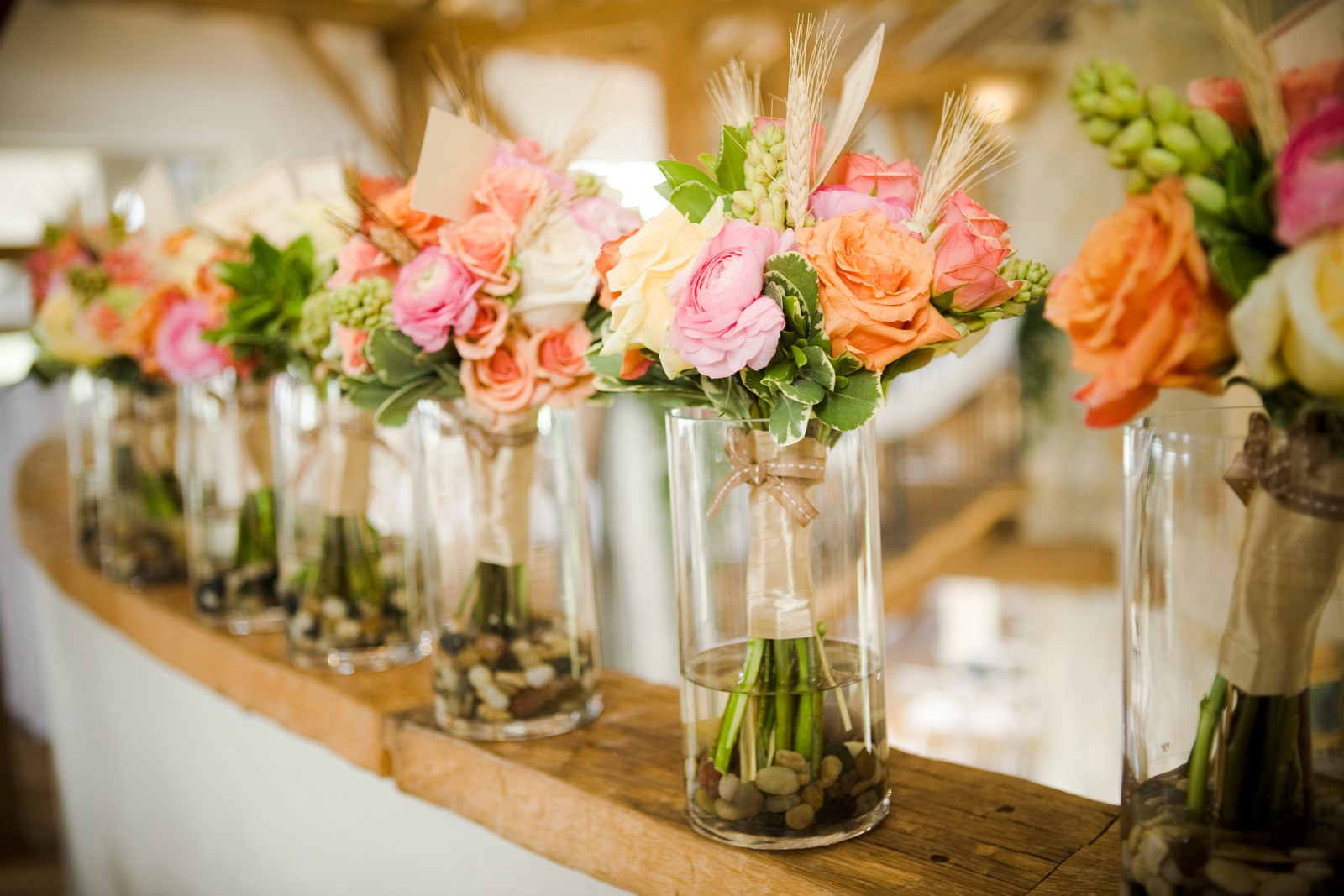 Simple But Modern Floral Bunches in Table Glasses - Bright Flowers with Rustic Feel of Rocks and Country Bow