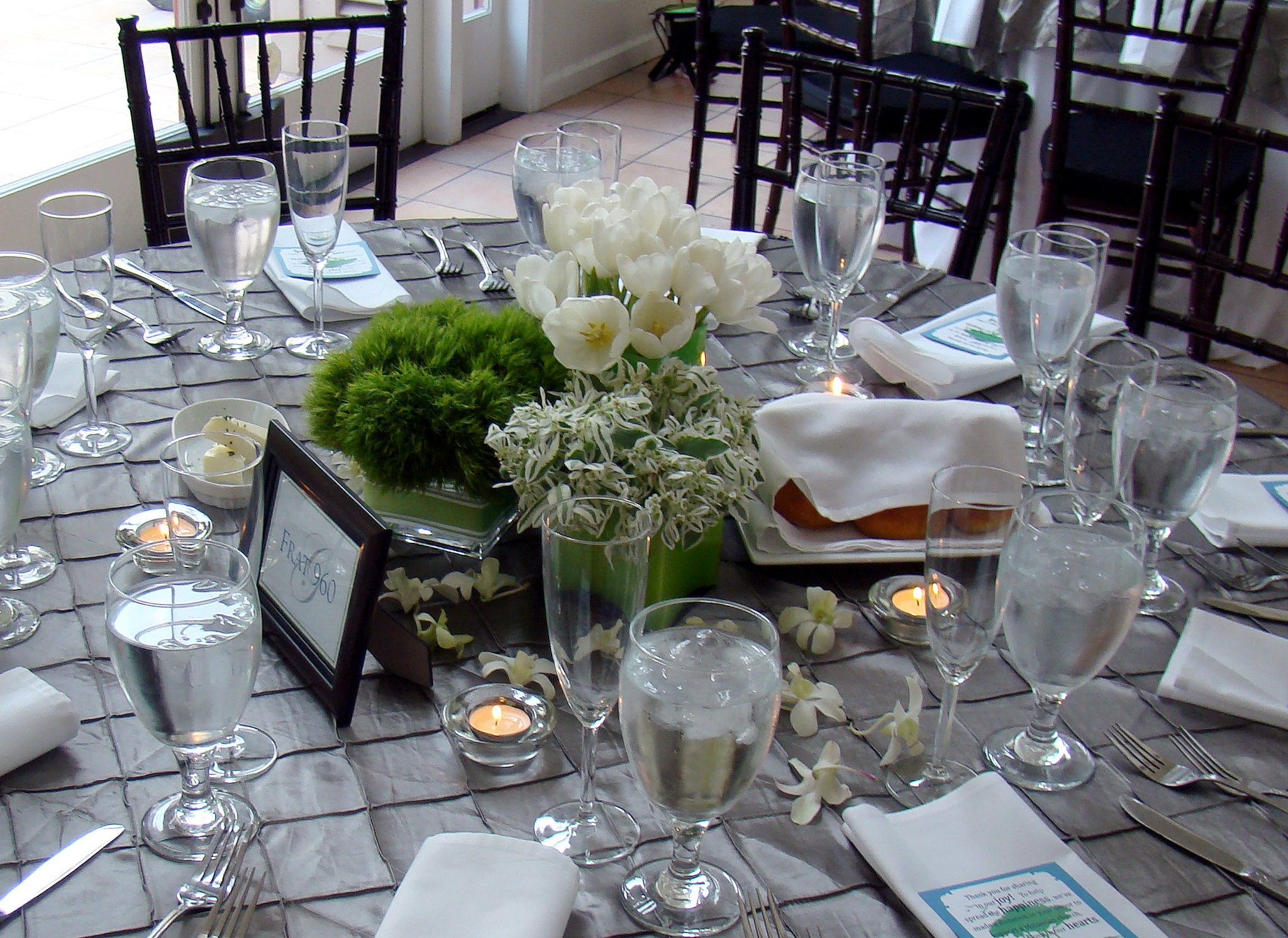 Traditional Round Wedding Table with White and Green Floral Centerpiece