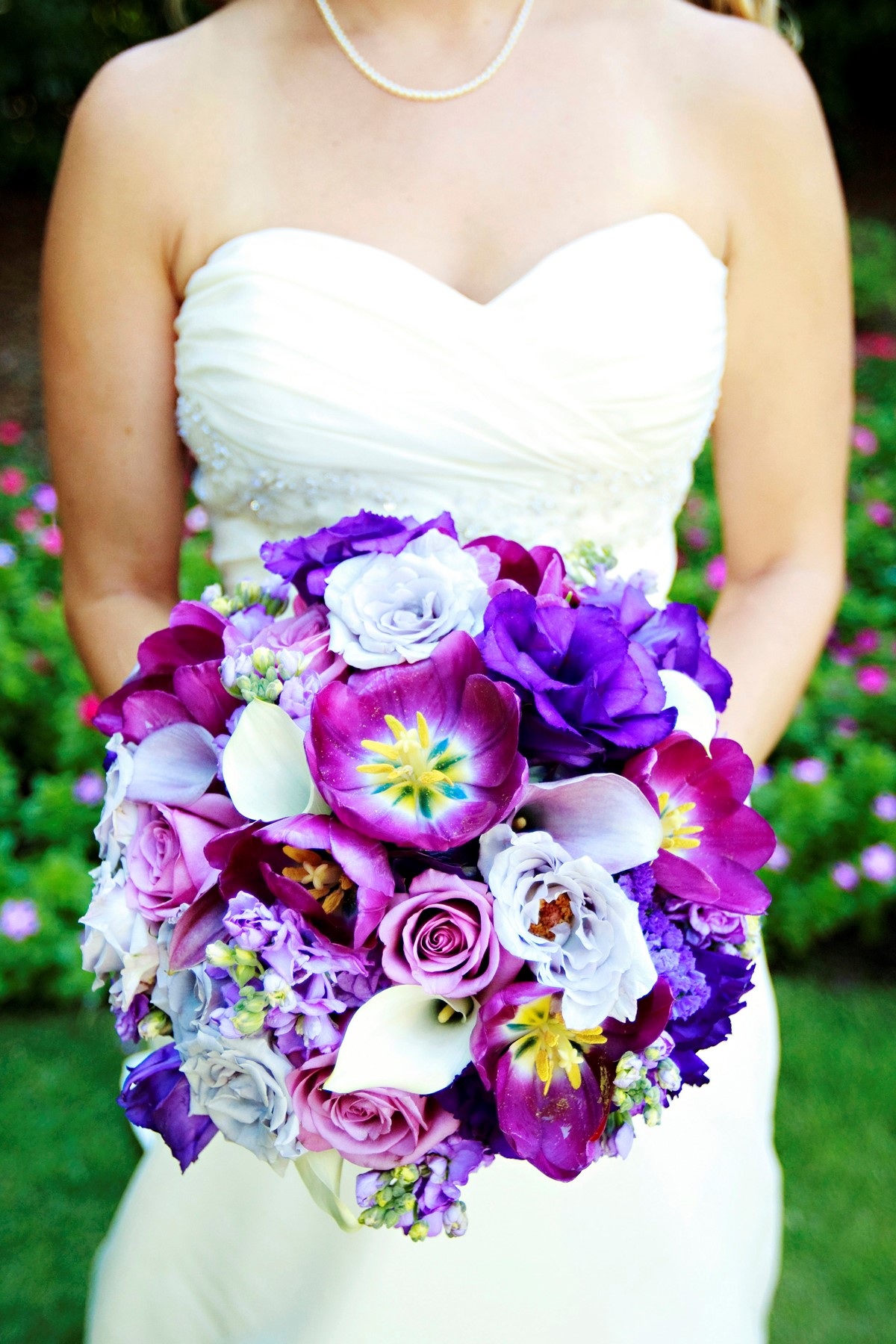 Bride Holding Gorgeous Purple, Blue and White Tropical Wedding Bouquet
