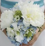 Bride with pretty white and blue wedding bouquet